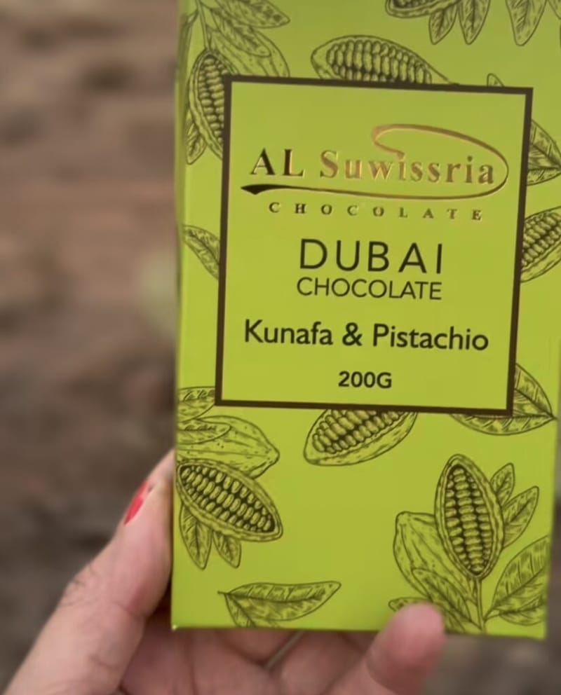 Al Suwissria Dubai Chocolate box, Kunafa and Pistachio flavor, 200g, held in hand outdoors