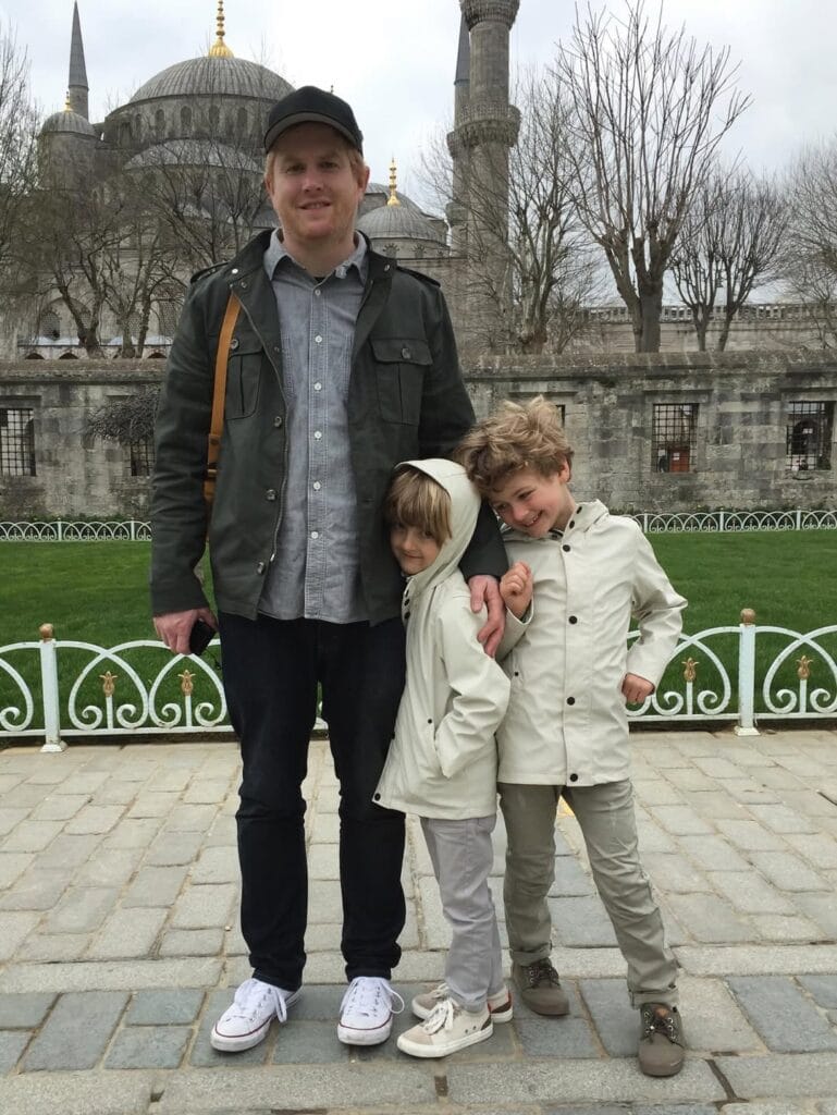 Paul Ferney and two children posing in front of the Blue Mosque in Istanbul